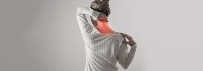Acupuncture Flower Mound TX Neck Pain A woman holding her neck in pain.