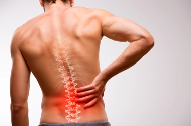 Acupuncture Flower Mound TX Spinal Decompression HP A man holding his back in pain.
