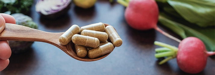 Acupuncture Flower Mound TX Supplements A spoon full of pills with radishes in the background.
