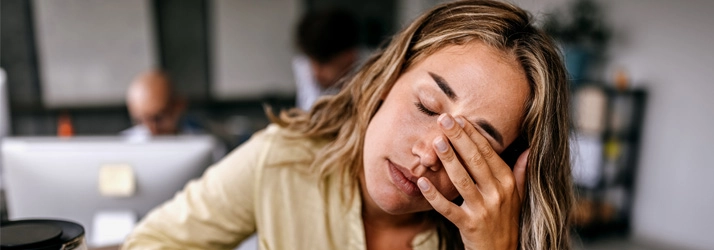 Acupuncture Flower Mound TX Woman Stressed A blonde woman holding her forehead.