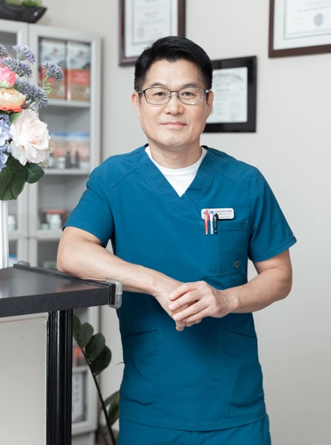 Acupuncturist Flower Mound TX Choong Shim Thank You Acupuncturist Choong Shim smiling in teal scrubs.