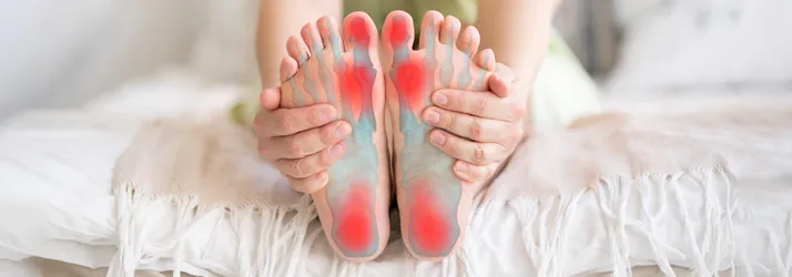Chiropractic Flower Mound TX Foot Pain A person holding their feet in pain.