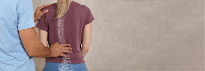 Chiropractic Flower Mound TX Scoliosis A chiropractor examining a patient with scoliosis.