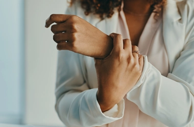 A person holding their wrist.