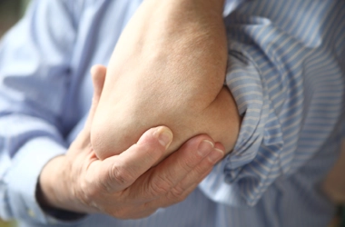 A person holding their elbow.