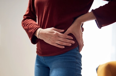 A person holding their hip.