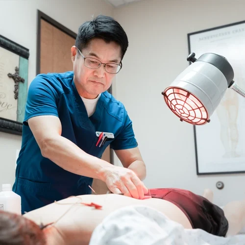 Acupuncturist Flower Mound TX Choong Shim With Patient HP Dr. Choong Shim with an acupuncture patient.