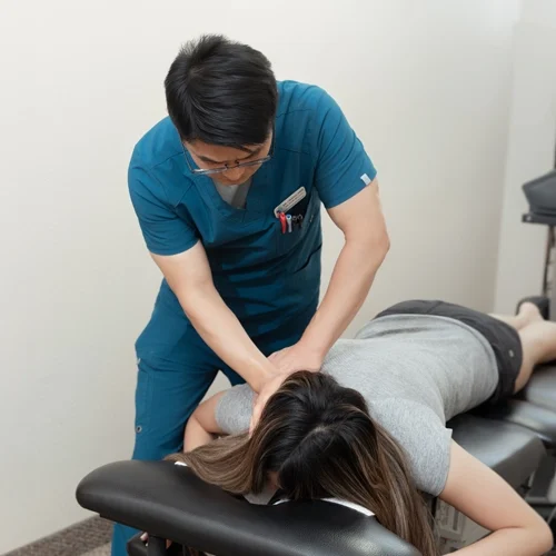 Chiropractor Flower Mound TX Choong Shim With Patient HP Dr. Choong Shim adjusting a patients shoulder.